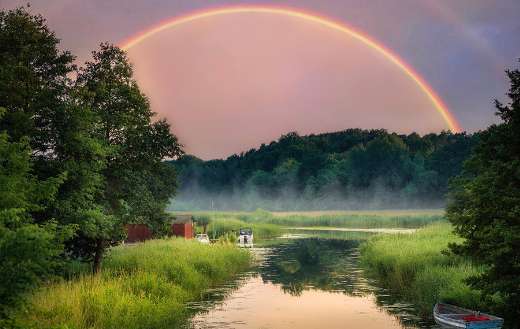 Lake water landscape with rainbow