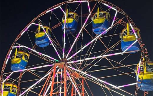 A ferris wheel illuminated in the dark