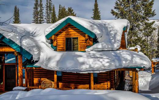 Cabin log covered with snow