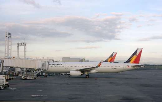 Philippine airlines plane docked at a gate