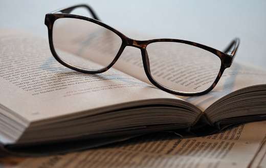 Pair of glasses on an open book