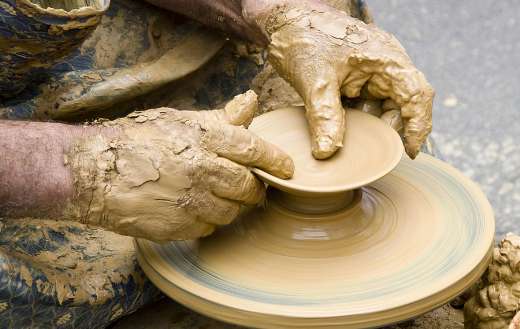 Potter shaping an object from clay