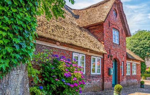 Tradional house with thatched roof walls red brick