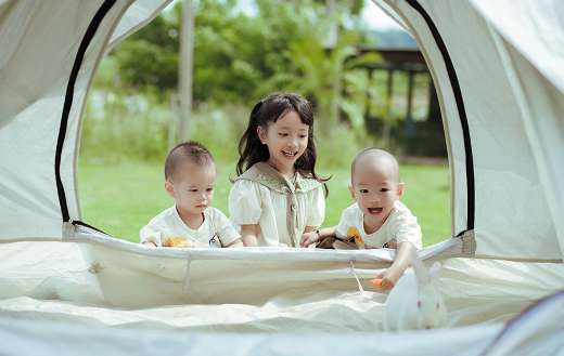 Young children playing in the tent