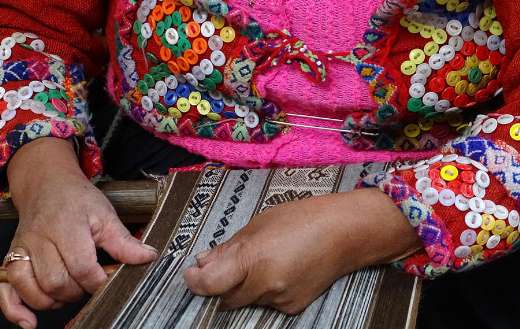 Peruvian woman weaving traditional textile
