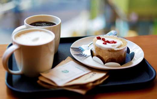 Two cups of coffee and pastry