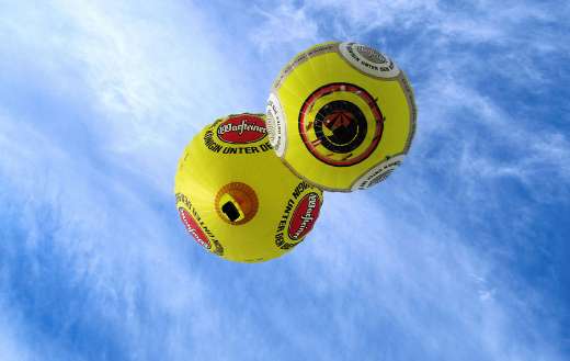 Two yellow hot air balloon with Warsteiner beer logo