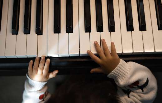 Close up keyboard being played young child