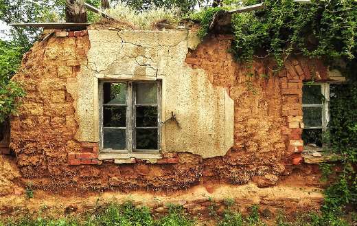Dilapidated building with walls made of clay