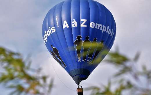 Blue air balloon against cloudy sky