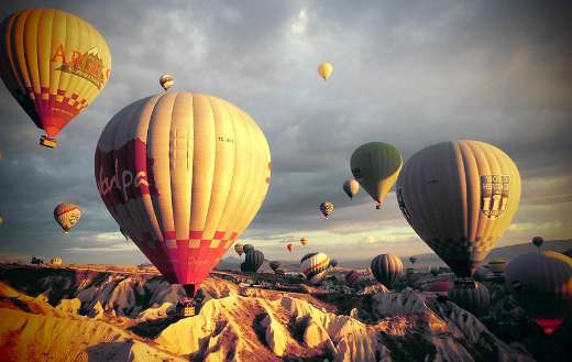 Iconic landscape of Cappadocia with air balloons